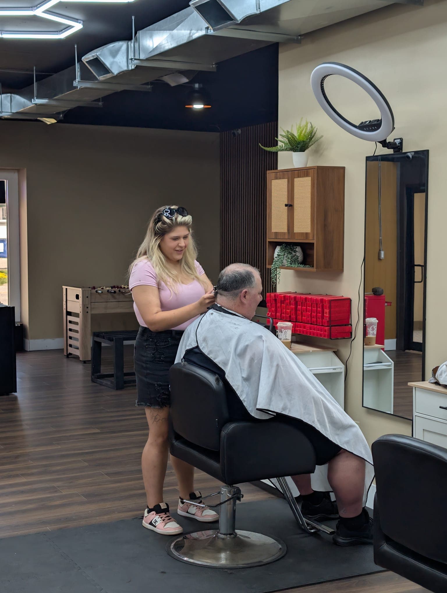 A stylist cutting a senior client's hair at Open Chair