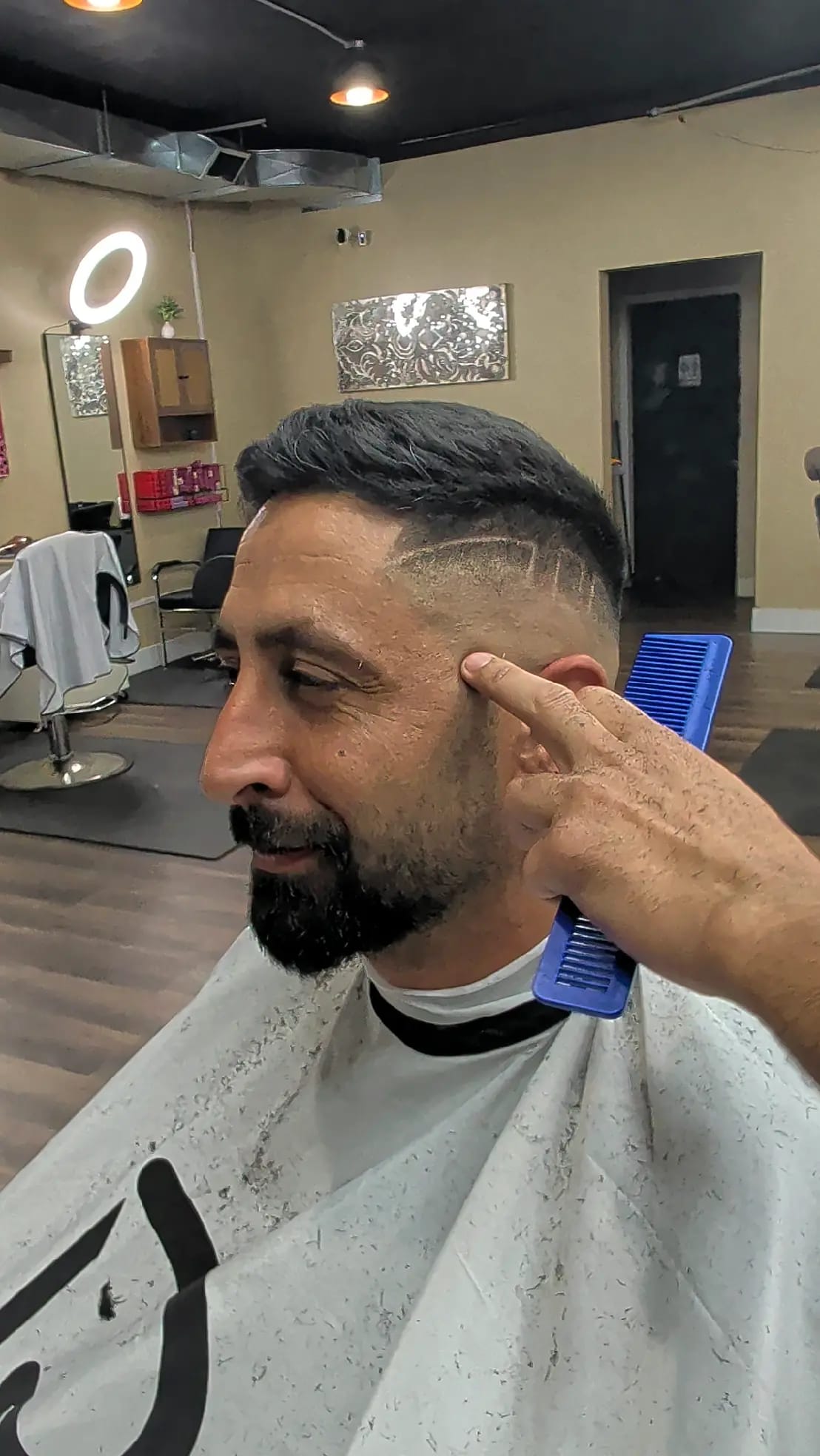 A barber lining up a hard part design