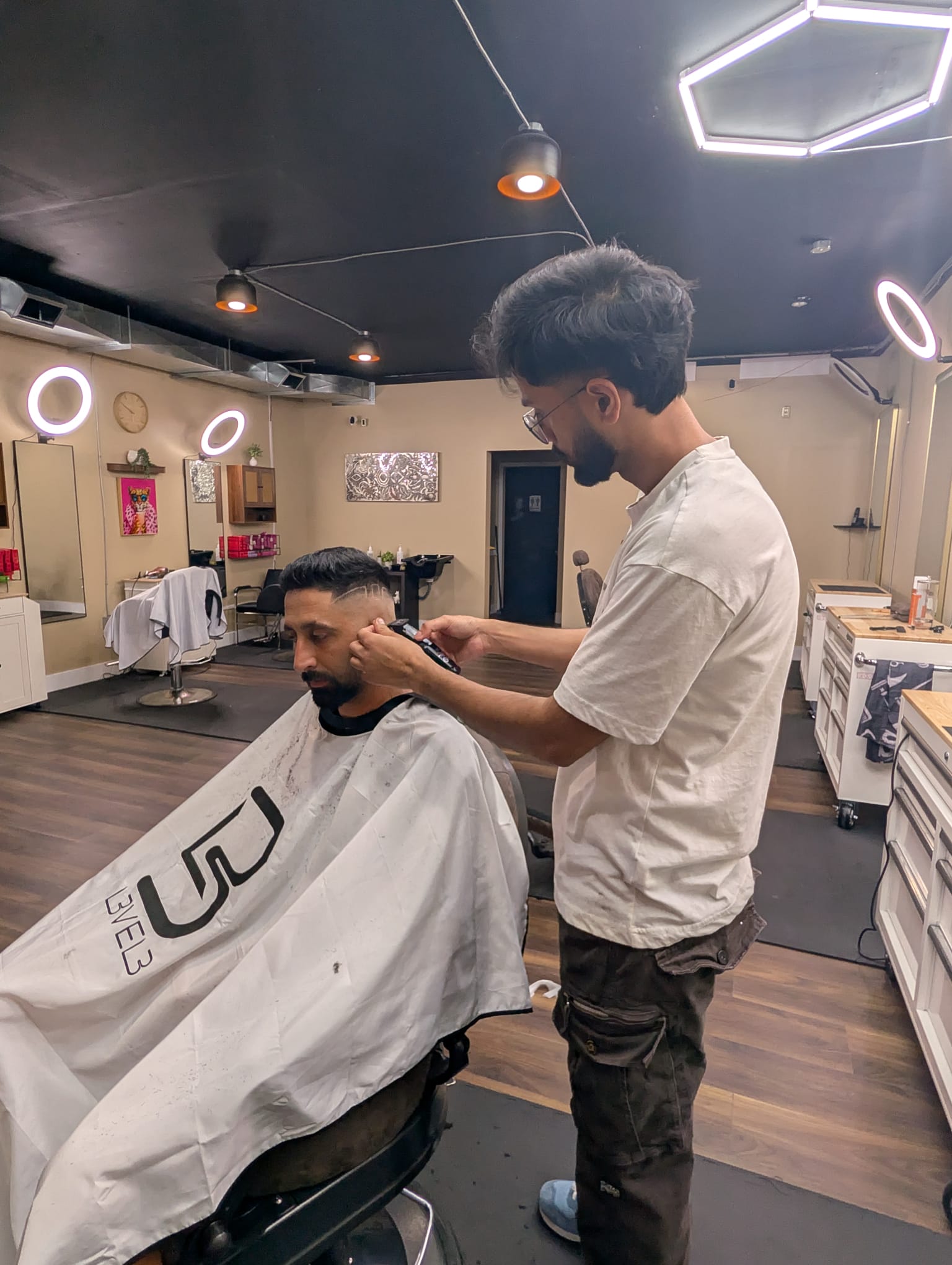 Wide view of the barbershop under its hexagon lighting