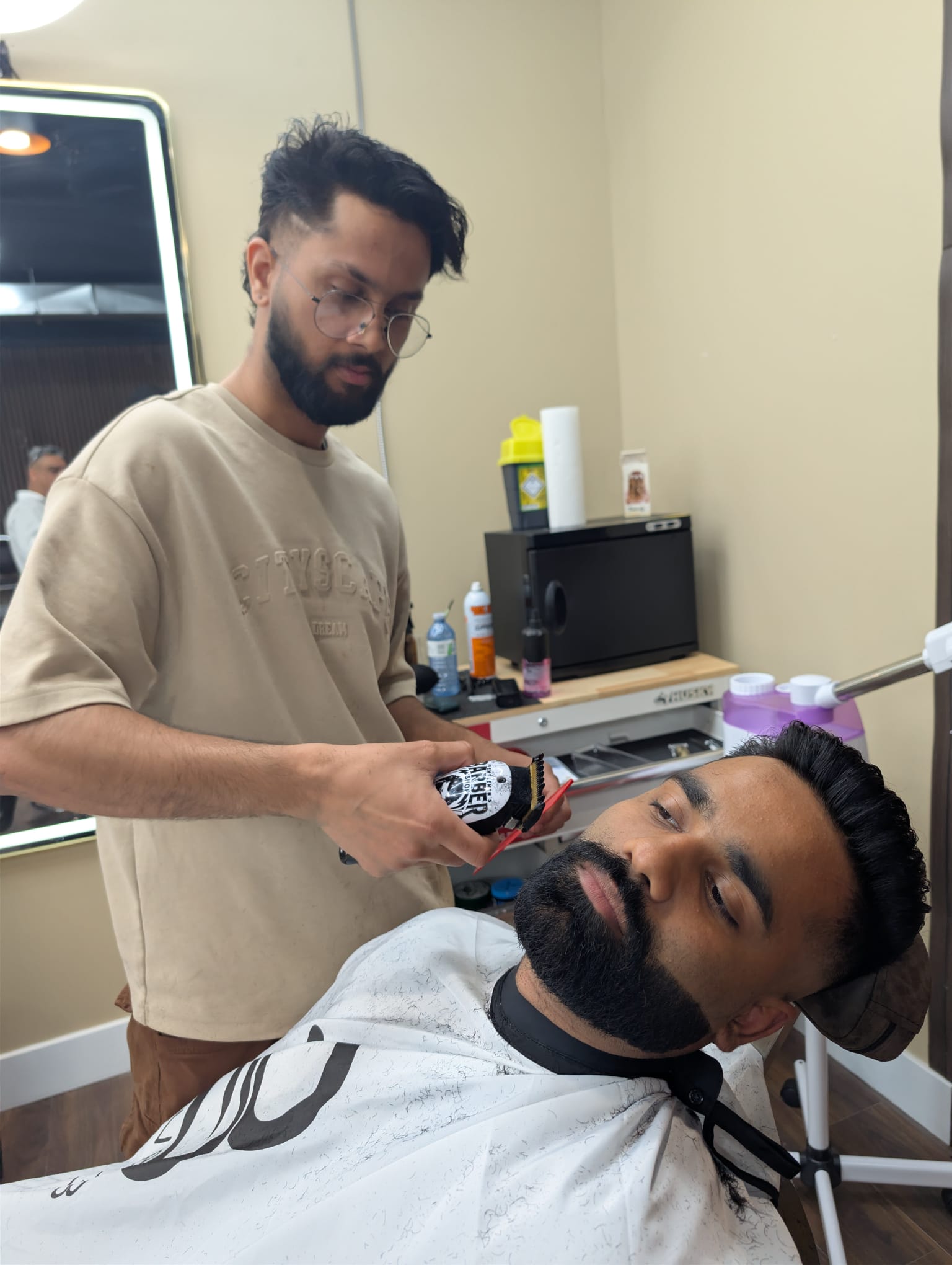A reclined beard trim beside the hot towel warmer